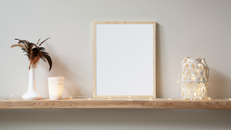 A framed white background leaning against a wall