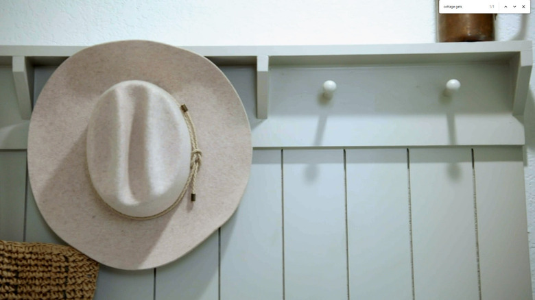 Hat hanging on pegs on mudroom wall