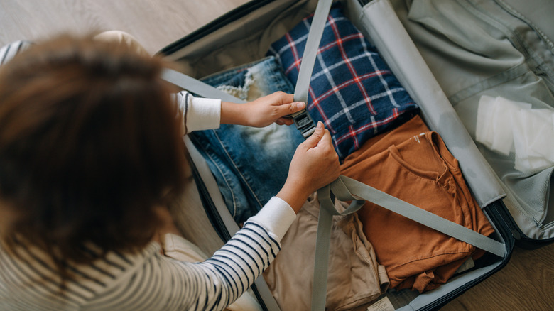 woman packing suitcase