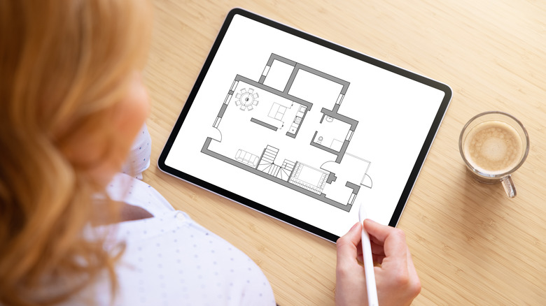 Woman developing floorplan on tablet