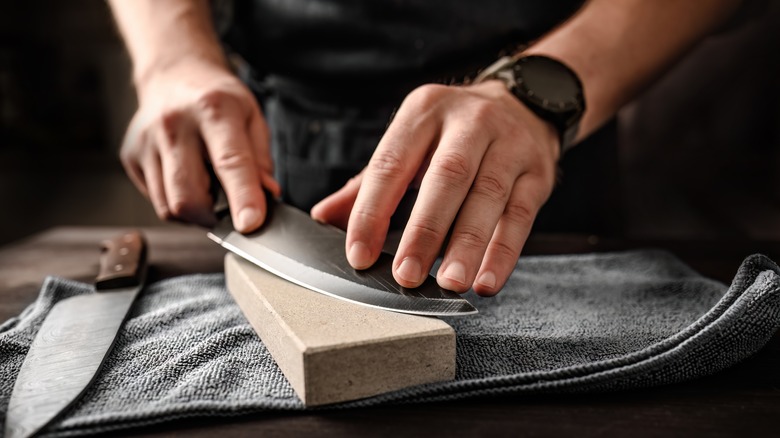 Man sharpening knife