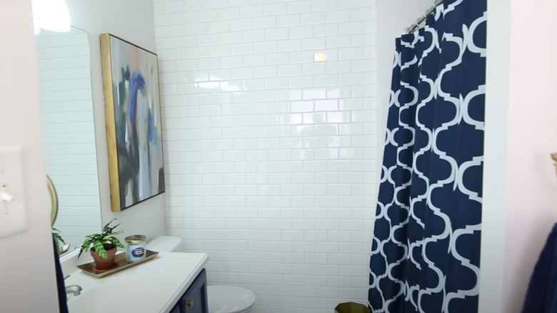 white bathroom with blue curtain