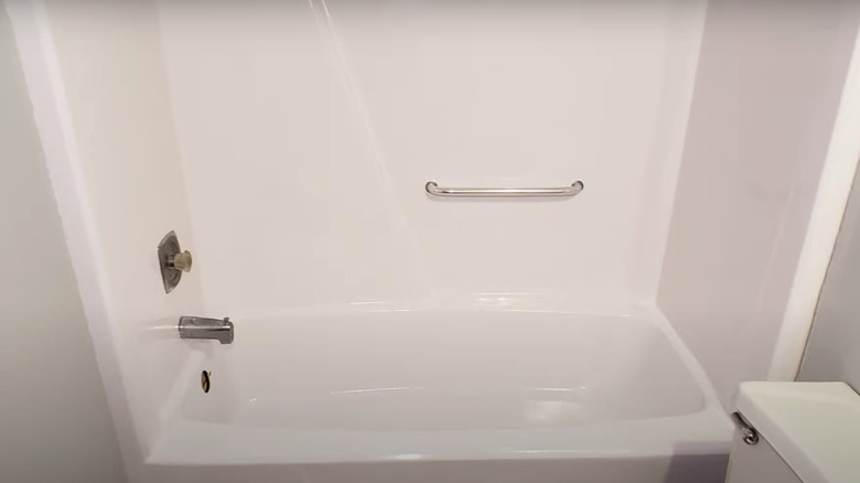 white bathtub and shower combination