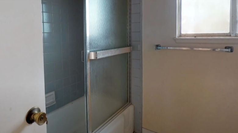 blue tiled shower with door