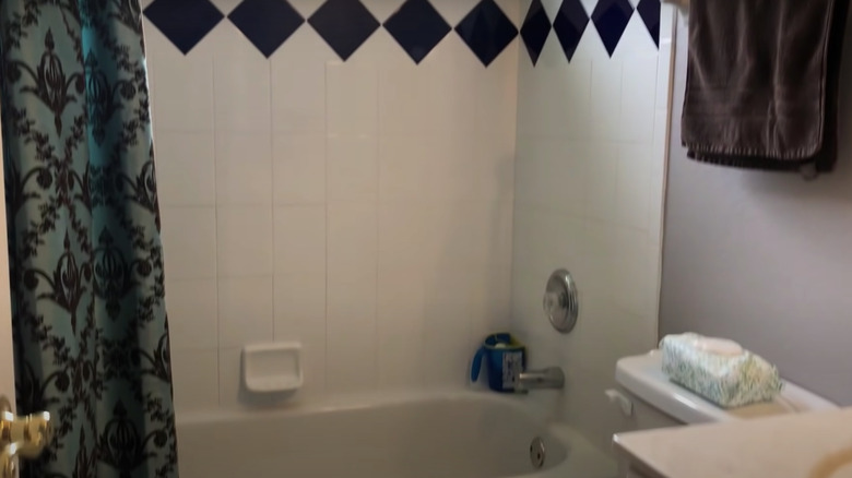 blue shower tiles with tub