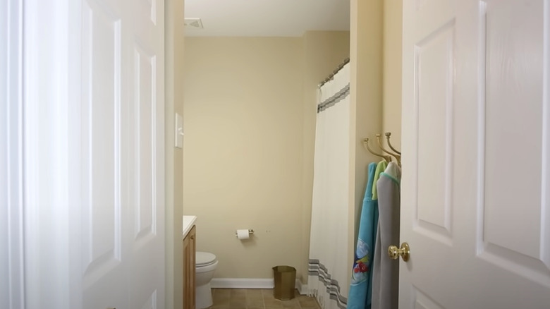 yellow bathroom with white curtain