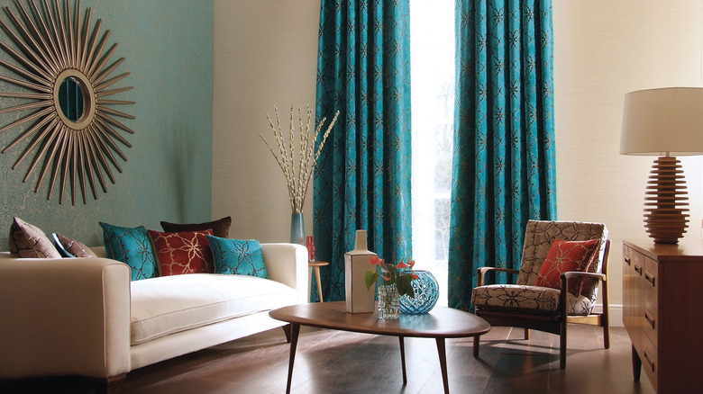 A beige and blue living room with bright blue curtains