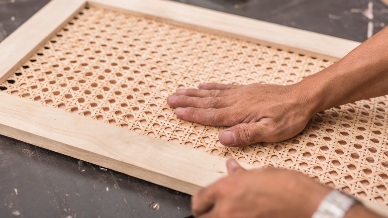 hand on cane cabinet door