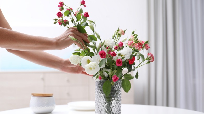 Arranging flowers in vase