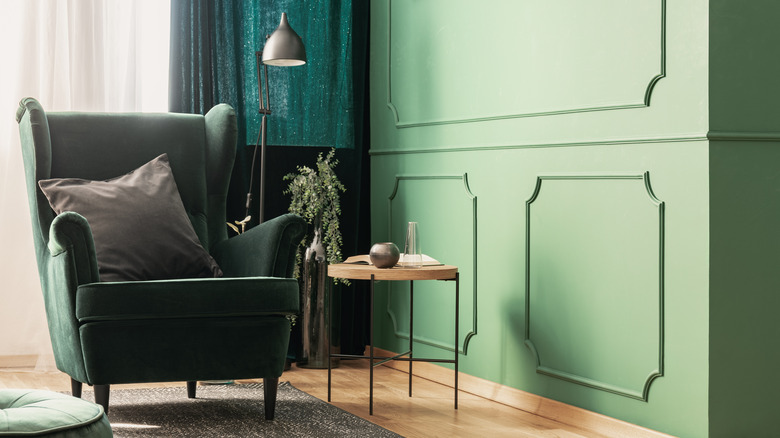 green accent chair in the corner