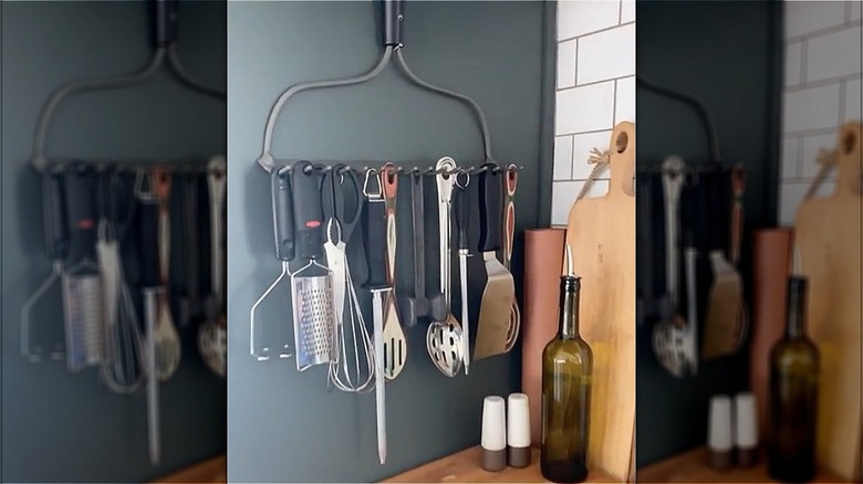 kitchen utensils hanging from rake 