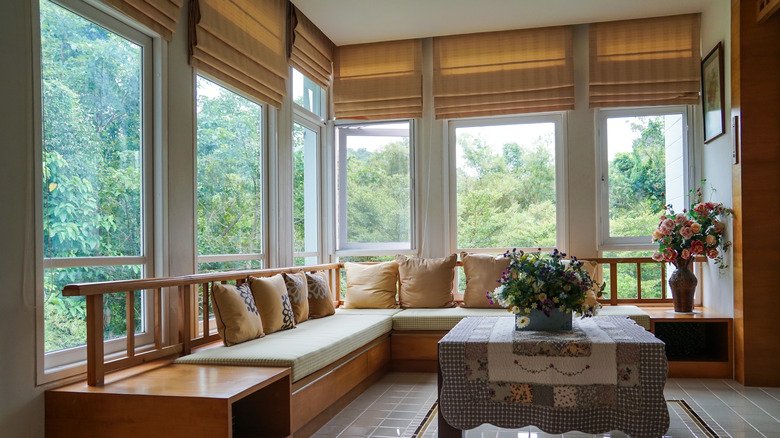 Neutral roman shades covering windows