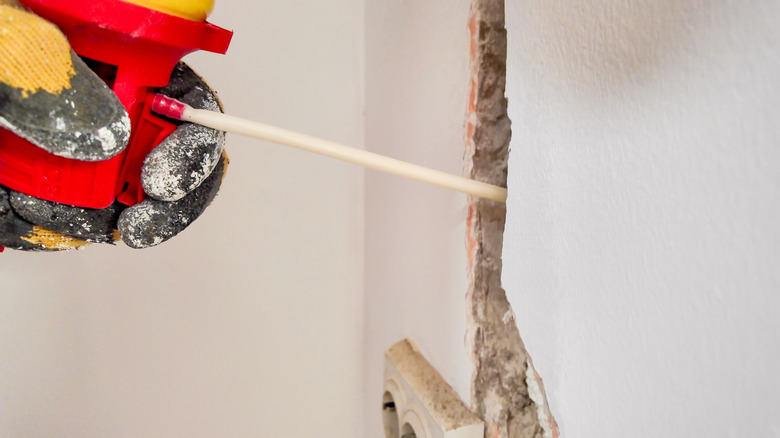 Foam insulation spray applied to crack in wall