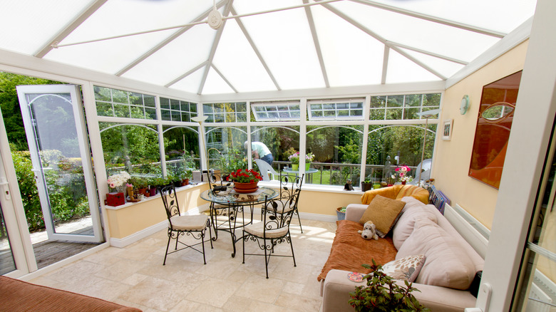 sunroom with roof and chairs