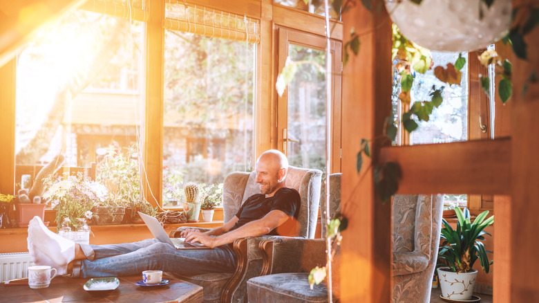 man smiling in sunny room