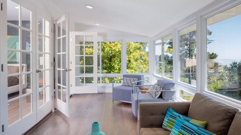 sunroom with open doors and chairs