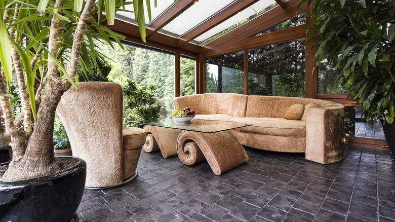 sunroom with couch and plants