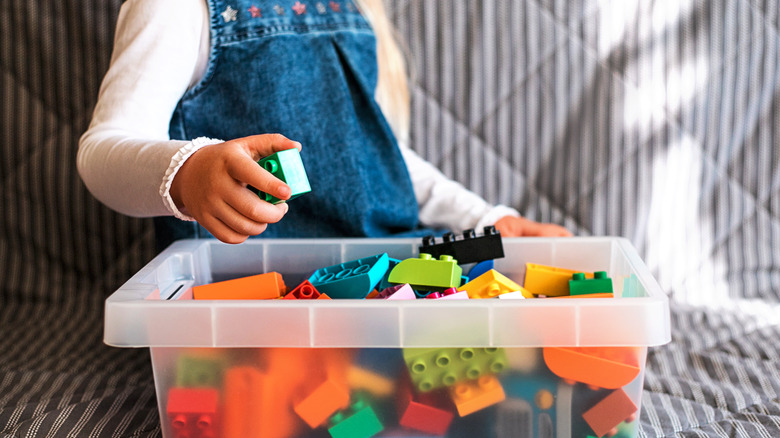 child playing with colorful blocks 