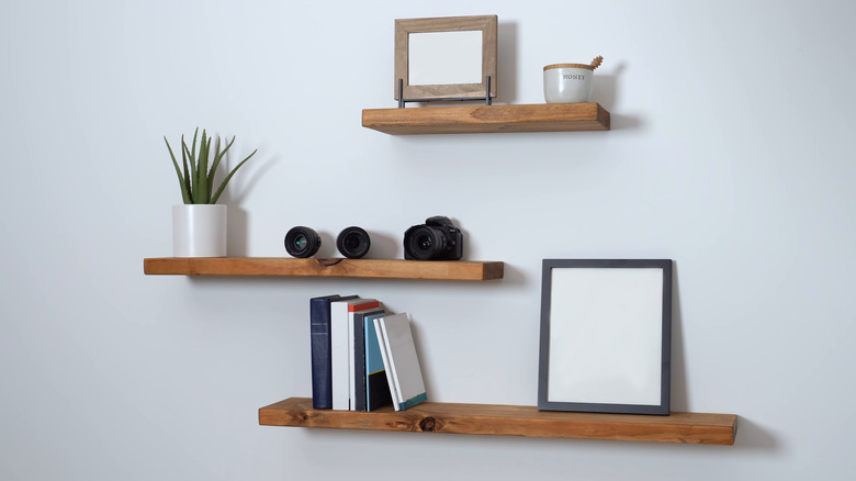 three floating shelves on wall