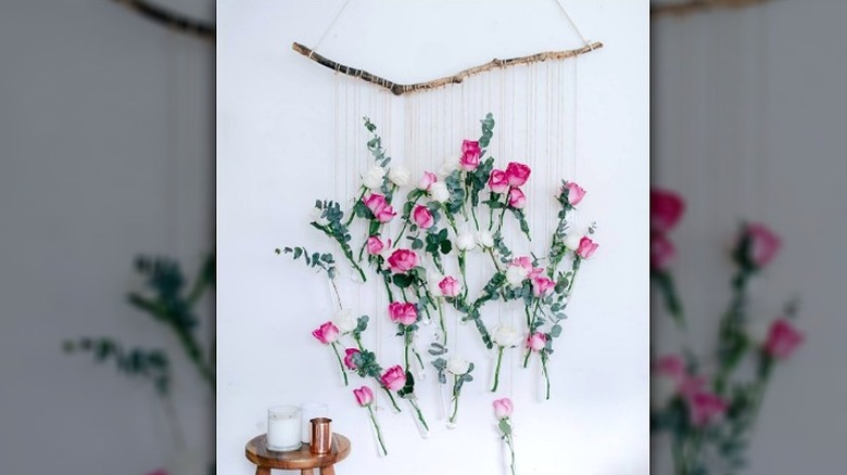 small vases suspended with branch