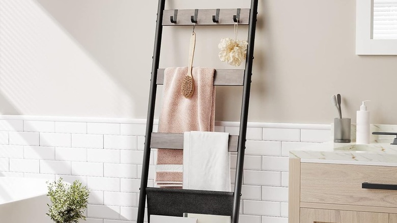 A leaning ladder towel rack in the bathroom