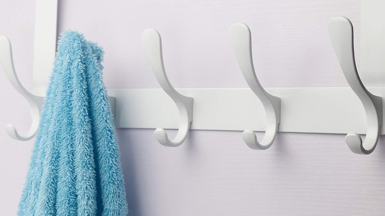 An over-the-door towel rack with a towel hanging on it