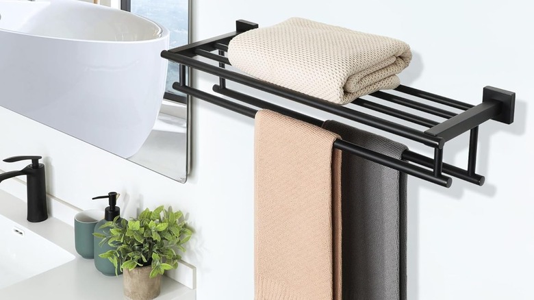 A towel rack with a shelf in the bathroom