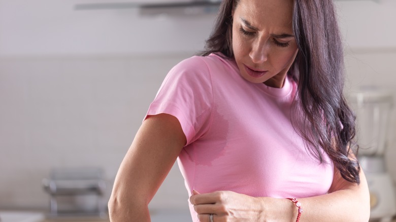 woman looking at sweat stain