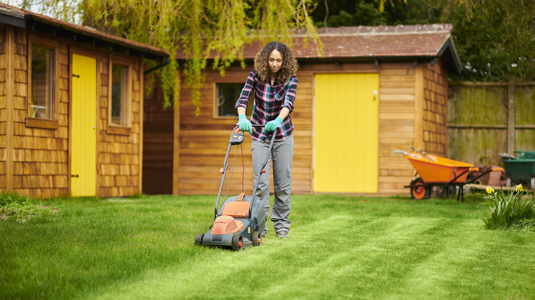 woman mowing her natural lawn