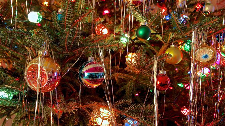 Christmas tree with colorful lights, ornaments, and tinsel