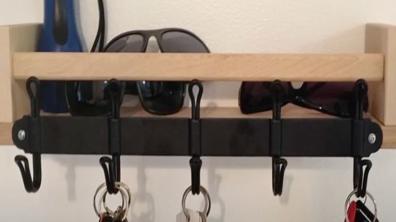 Spice rack converted into storage for keys and sunglasses