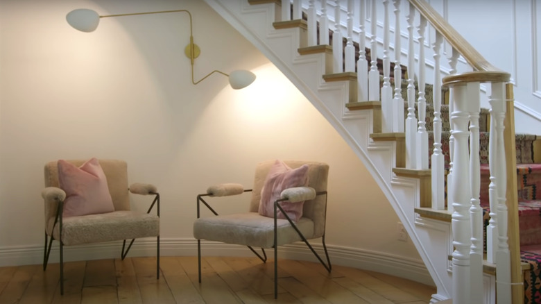 white wooden staircase with chairs