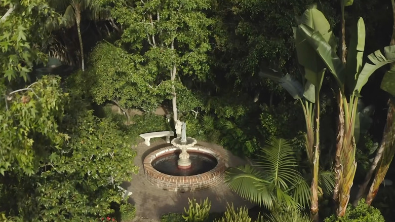 fountain with bench in backyard