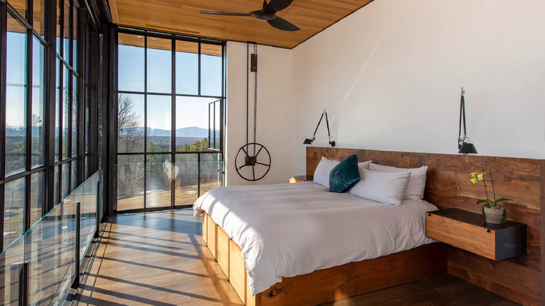 bedroom facing large windows