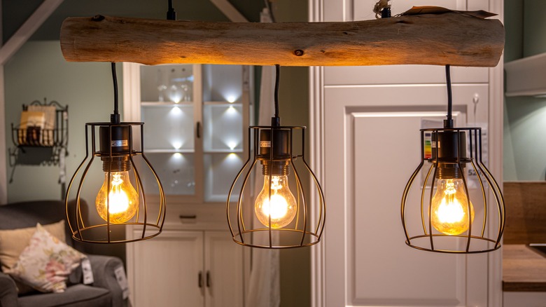 Industrial-style pendant lights with Edison light bulbs hanging from a kitchen ceiling.