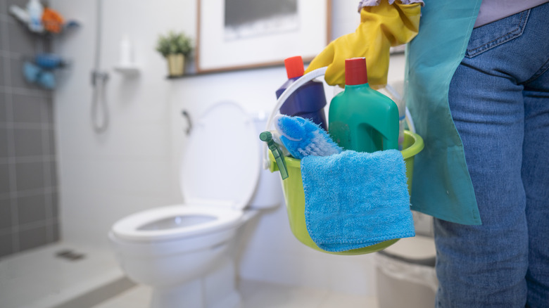 Holding cleaning supplies in bathroom