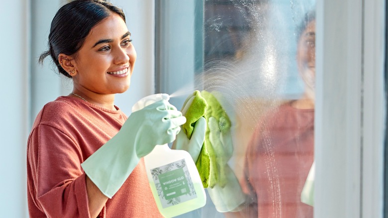 woman cleaning window