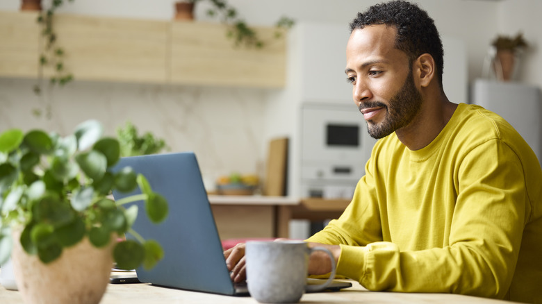 A man working remotely from his comfortable home office desk