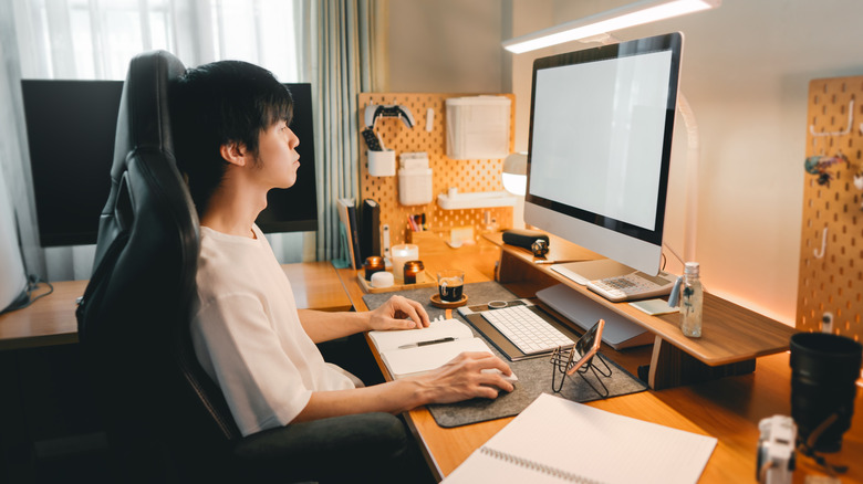 A person sitting at an ergonomic home office desk