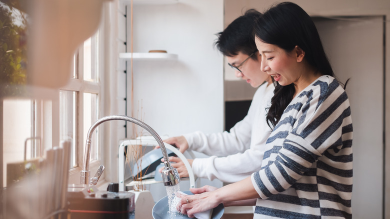 couple washing dishes