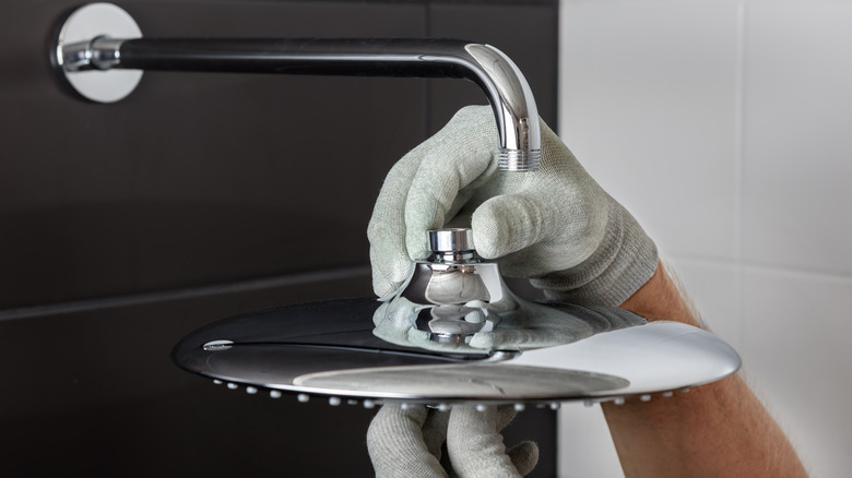 Hand installing new showerhead