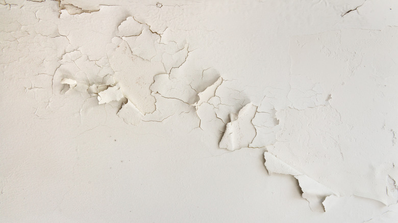 Peeling paint on a white wall