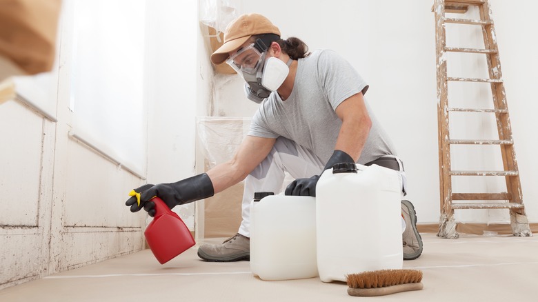 man cleaning mold in house