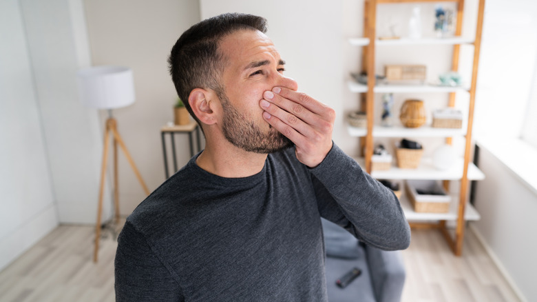 Man smelling a foul odor