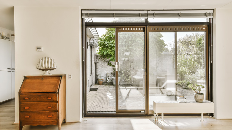 Sliding glass doors that open up to a backyard patio