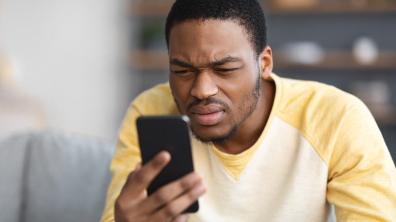 man confused by phone