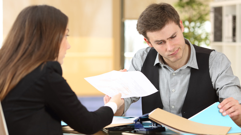 unconcerned man receives paper