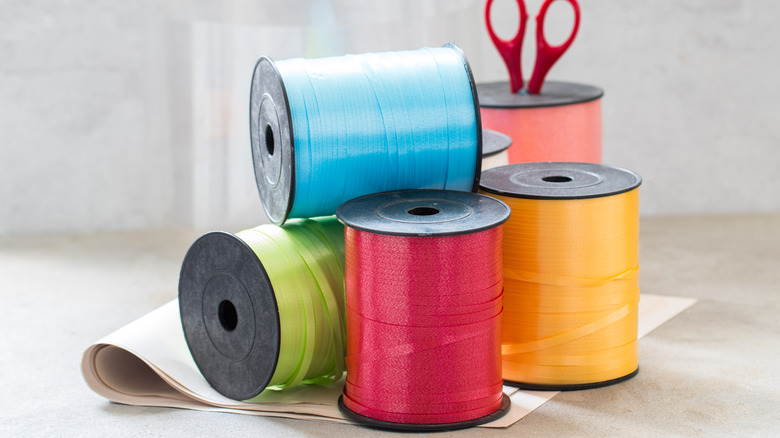 Colorful ribbon spools on table.