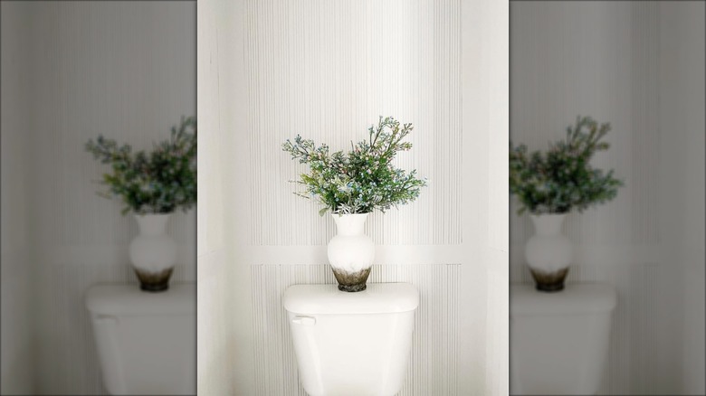 White fluted panels behind toilet