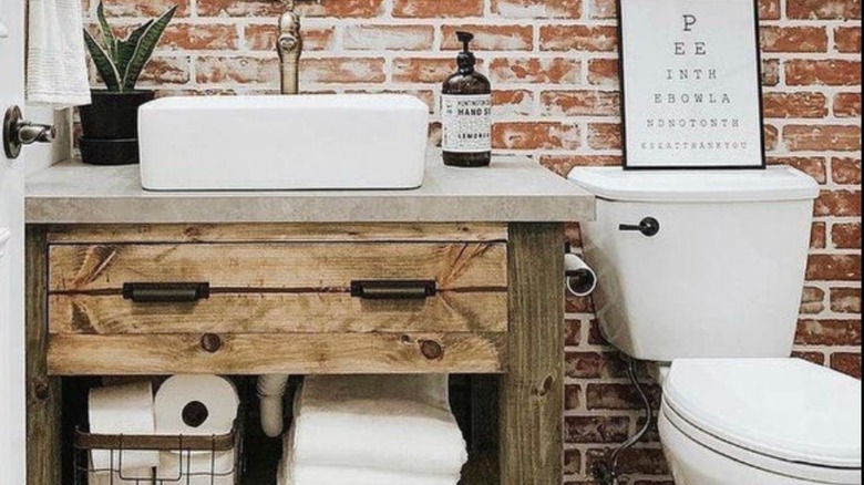 Brickwork behind toilet and sink